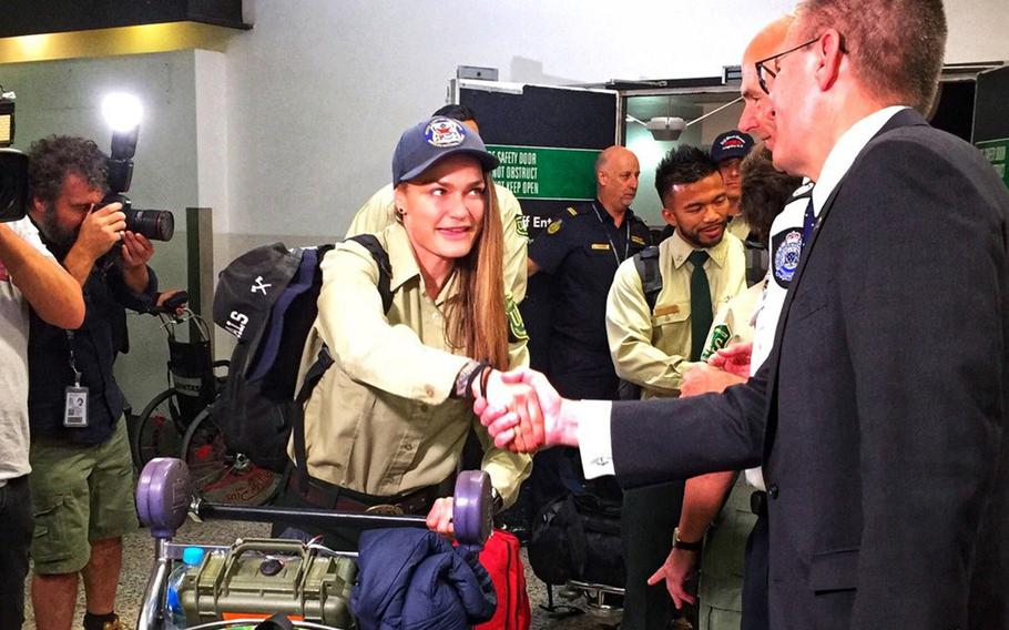 Acting U.S. Consul-General Jeff Shelstad greets American firefighters arriving in Melbourne, Australia, to help battle bushfires, Wednesday, Jan. 8, 2019.