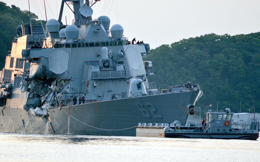 The guided-missile destroyer USS Fitzgerald returns to Yokosuka Naval Base, Japan, following a collision with a merchant vessel that killed seven sailors, June 17, 2017.