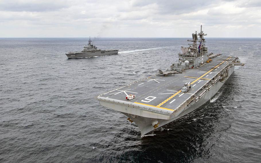 The amphibious assault ship USS America and the Japan Maritime Self-Defense Force amphibious transport dock ship JS Kunisaki steamed together in the East China Sea on Jan. 13, 2020.