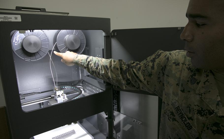 Marine Staff Sgt. Quincy Reynolds of the III Marine Expeditionary Force's 3rd Maintenance Battalion shows off the unit's new Markforged Metal X 3D printer at Camp Kinser, Okinawa, Jan. 16, 2020.