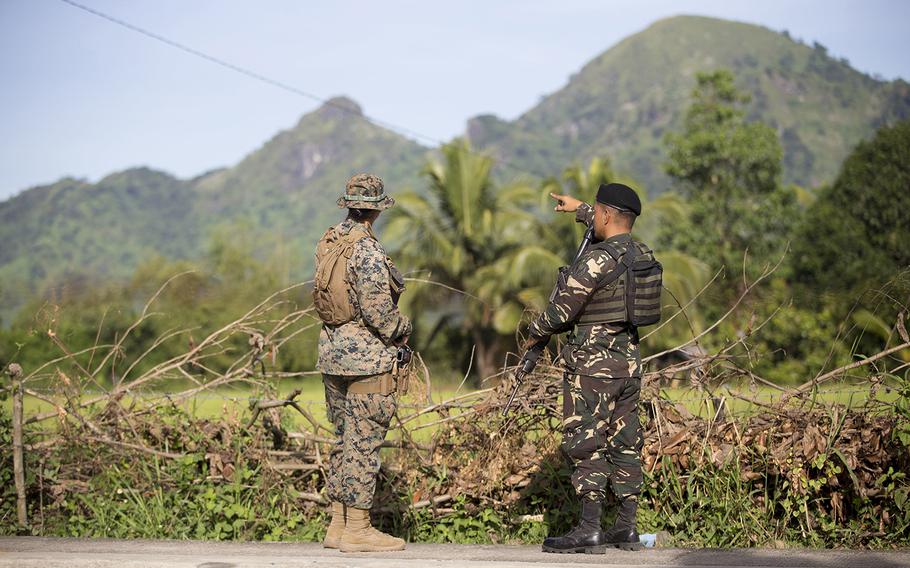 A Philippine Air Force airman chats with a U.S. Marine during training at Colonel Ernesto P. Ravina Air Base, Philippines, Oct. 9, 2019.