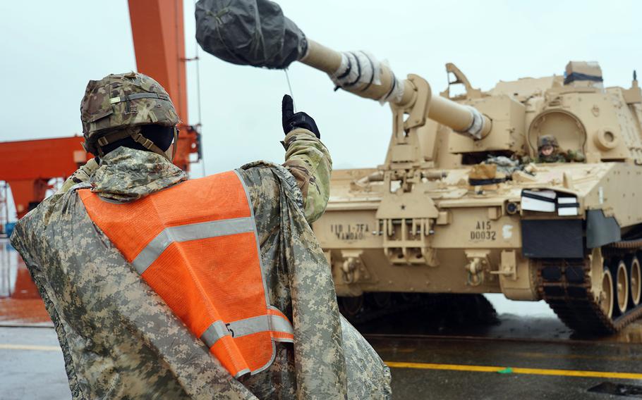 Tanks and other equipment are off-loaded at a port in South Korea ahead of the arrival of the Fort Riley, Kansas-based 2nd Armored Brigade Combat Team, 1st Infantry Division.