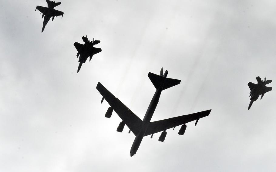 A B-52 Stratofortress bomber flies alongside fighter jets over Andersen Air Force Base, Guam, during the multinational Cope North exercise, Wednesday, Feb. 19, 2020.