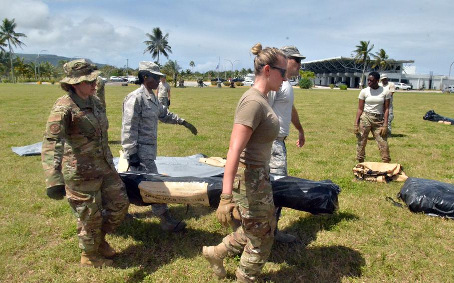 Troops taking part in the multinational Cope North exercise work to set up a four-bed field hospital on the island of Rota, Tuesday, Feb. 18, 2020.