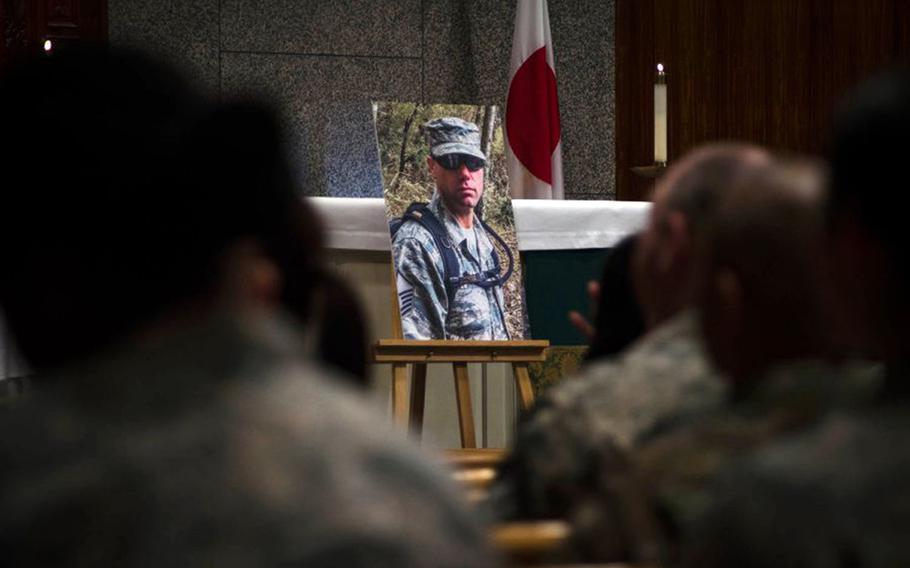 Service members attend a memorial ceremony for Master Sgt. Nicholas Vollweiler at Yokota Air Base, Japan, Nov. 16, 2018.