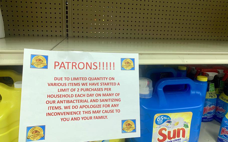 A sign above an empty shelf informs commissary customers at Yokosuka Naval Base, Japan, of purchase limits for antibacterial and sanitation products, Thursday, Feb. 27, 2020.