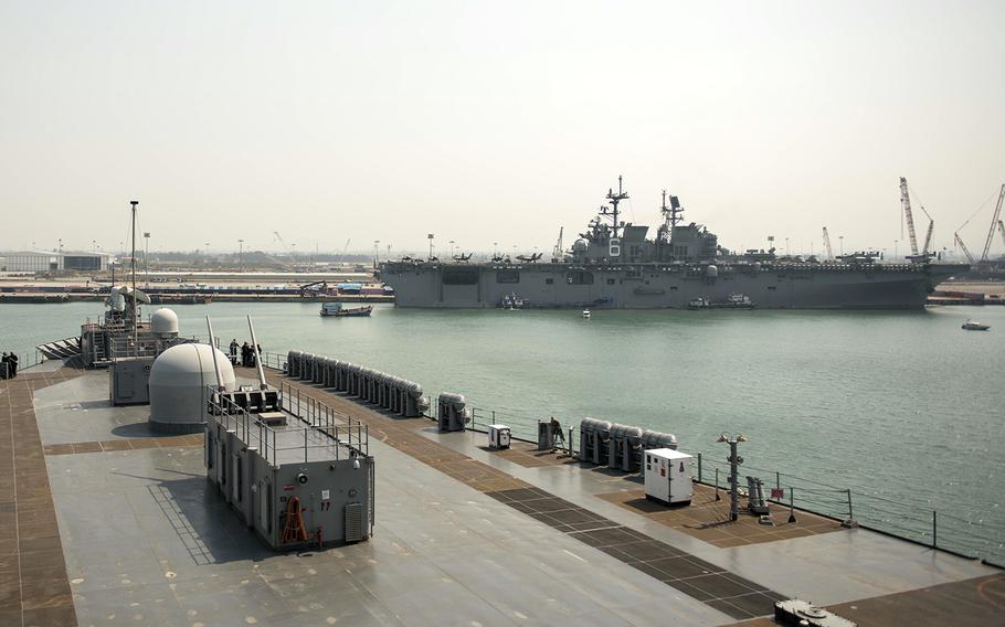 The amphibious assault ship USS America is seen from the 7th Fleet flagship USS Blue Ridge in Laem Chabang, Thailand, Feb. 23, 2020.