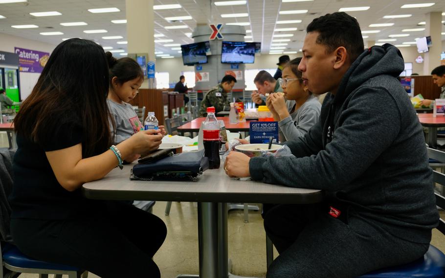 Staff Sgt. Vincent Lim of the 731st Air Mobility Squadron and his wife, Joy Mae Lim, eat with their children at the food court on Osan Air Base, South Korea, Monday, March 2, 2020.