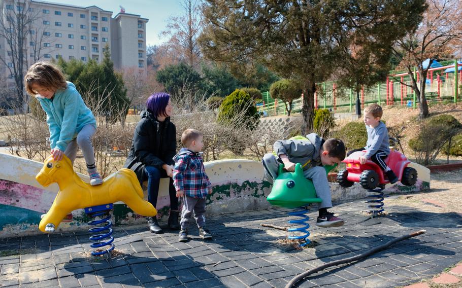 Cindy Badger, a military spouse, watches her four children at a playground on Osan Air Base, South Korea, Monday, March 2, 2020.