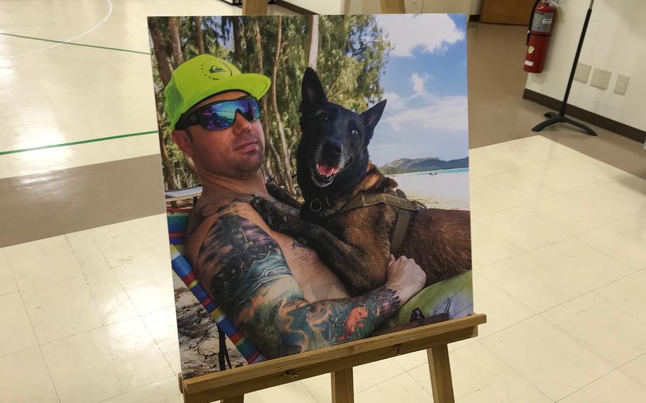 A photo of Master Sgt. Nicholas Vollweiler is displayed during a memorial service at Yokota Air Base, Japan, in November 2018. He served as the security forces squadron's chief of standards and evaluation.