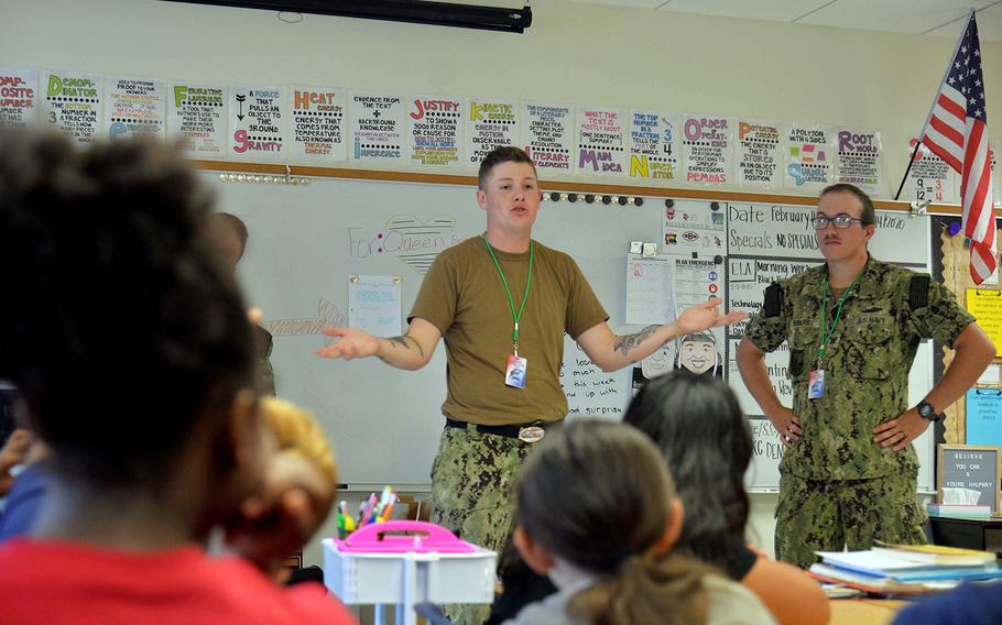 Sailors assigned to the submarine USS Oklahoma City visit fifth-grade students at McCool Elementary School on Naval Base Guam, Feb. 14, 2020.
