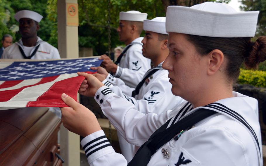 Sailors pallbearers fold the interment flag during the funeral of Seaman 2nd Class Hubert P. Hall at the National Memorial Cemetery of the Pacific, Hawaii, March 17, 2020. Hall died aboard the USS Oklahoma during the 1941 attack on Pearl Harbor.