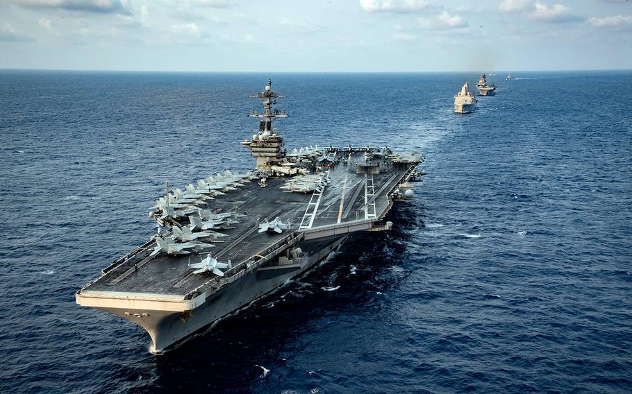 Ships from the Theodore Roosevelt Carrier Strike Group and the America Expeditionary Strike Group transit the South China Sea, March 15, 2020.