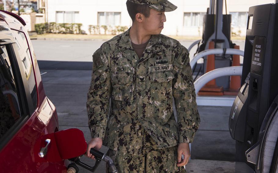 Petty Officer 3rd Class Philip Choi gases up his vehicle at Yokota Air Base in western Tokyo, March 20, 2020.