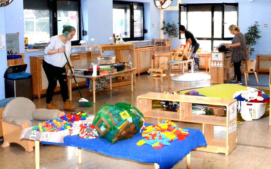 Staff members on a U.S. base in Germany deep clean a child development center as a precaution against coronavirus on March 19, 2020. Similar measures were taken at centers in Japan.
