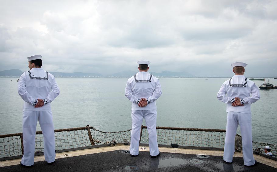 Sailors man the rails aboard the USS Bunker Hill as the guided-missile cruiser pulls into Da Nang, Vietnam, March 5, 2020.