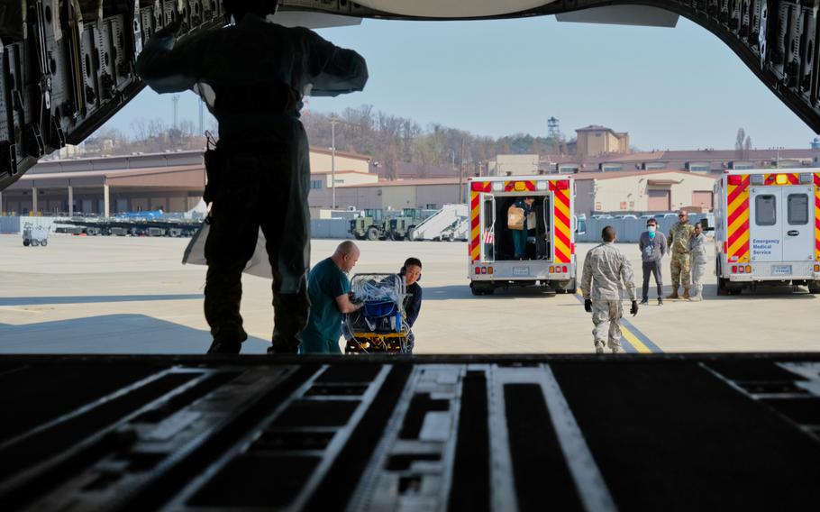 A baby born 10 weeks premature is transferred to a C-17 Globemaster III during a medical evacuation at Osan Air Base, South Korea, Monday, March 30, 2020.