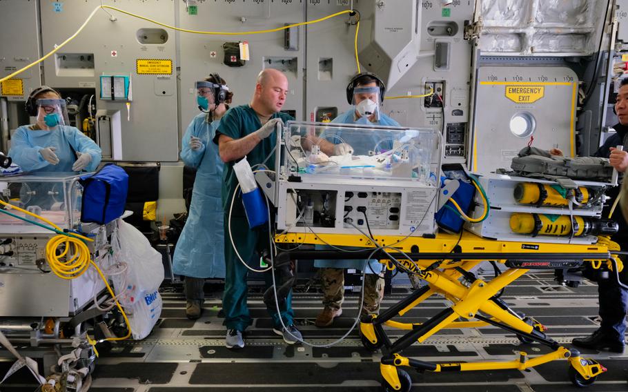 Babies born 10 weeks premature are transferred to a C-17 Globemaster III during a medical evacuation at Osan Air Base, South Korea, Monday, March 30, 2020.