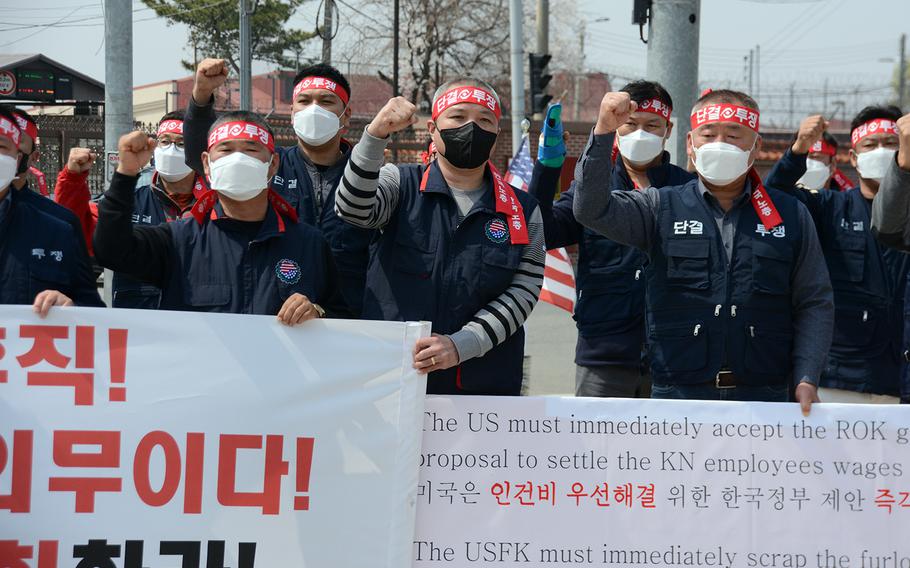 Members of the South Korean employees' union protest the U.S. Forces Korea furlough outside the main gate at Camp Humphreys, South Korea, Wednesday, April 1, 2020.