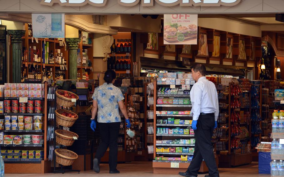 Workers at an ABC Store on Kalakaua Avenue, Waikiki Beach in Hawaii, clean and disinfect in the absence of customers, March 31, 2020.