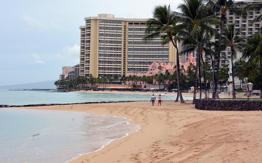 Two strollers have the Waikiki Beach seaside all to themselves, March 31, 2020.