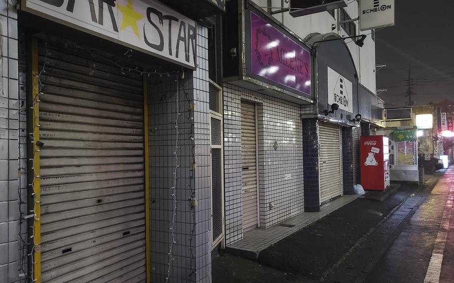 Many establishments were shuttered on the evening of March 31, 2020, at a popular entertainment district known as Bar Row near Yokota Air Base in western Tokyo.