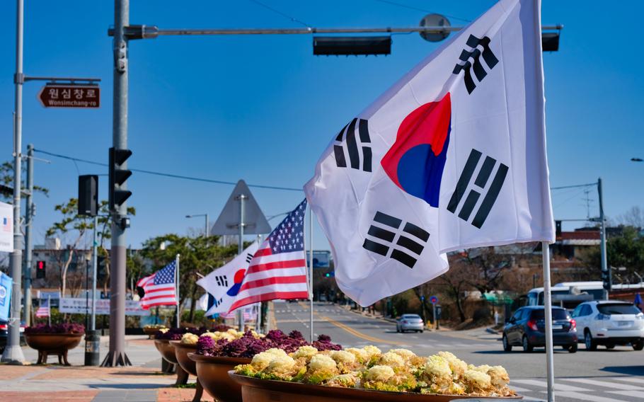 American and South Korean flags flap in the breeze outside Camp Humphreys, South Korea, March 16, 2020.