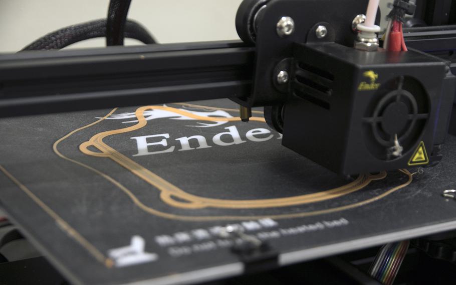 A Creality Ender 3 Pro 3D printer makes a face mask frame at the 3rd Maintenance Battalion's Camp Kinser warehouse, Wednesday, April 8, 2020.