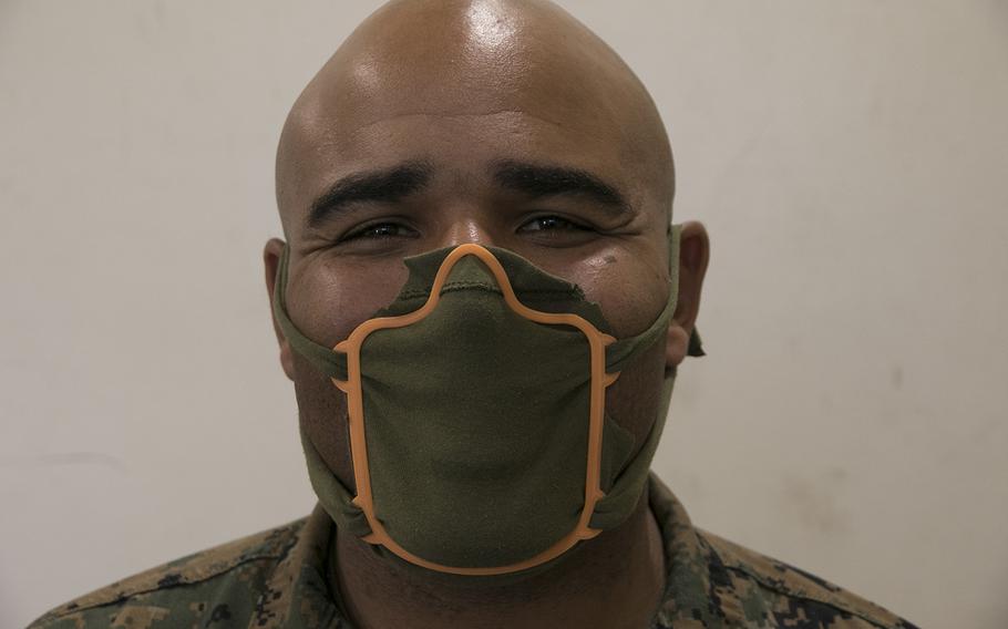 Marine Staff Sgt. Quincy Reynolds of the III Marine Expeditionary Force's 3rd Maintenance Battalion shows off his 3D printed face mask frame at Camp Kinser, Okinawa, Wednesday, April 8, 2020.