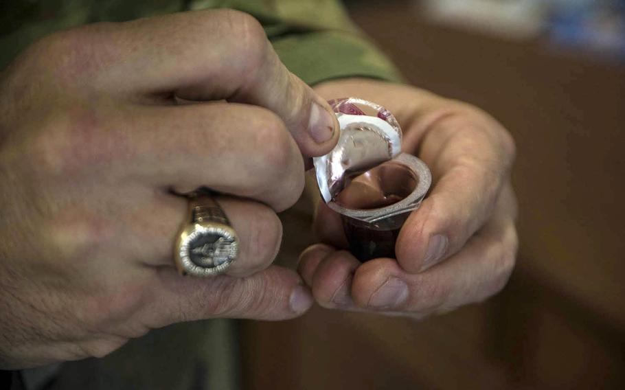 Lt. Col. Dale Marlowe, a chaplain at Yokota Air Base in Tokyo, explains how single-serving communion cups are helping people worship during the coronavirus pandemic, Thursday, April 9, 2020.