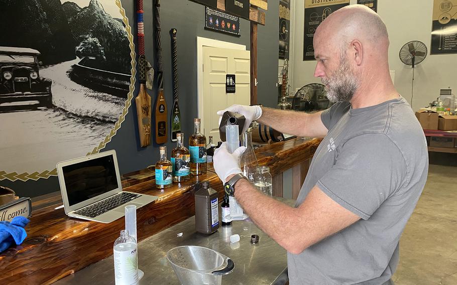 Eric Dill prepares a batch of ad hoc hand sanitizer at Ko'olau Distillery on Oahu, where he and co-owner Ian Brooks have stepped away from making whiskey temporarily to fill a need during the coronavirus pandemic.