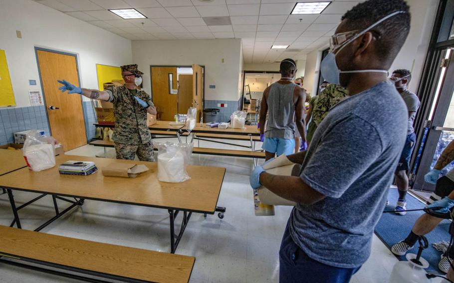 Sailors and Marines from 3rd Medical Battalion, 3rd Marine Logistics Group, sterilize a building at Naval Base Guam on April 9, 2020.