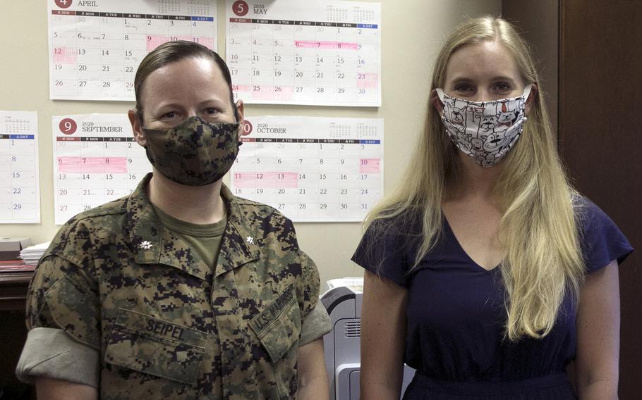 Lt. Col. Petra Seipel, left, executive officer for the III Marine Expeditionary Force Information Group, and Julie Ferns, a Marine spouse, show off their handmade masks at Camp Hansen, Okinawa, Tuesday, April 21, 2020.