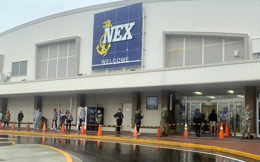 A sailor on shore patrol enforces social distancing requirements outside the exchange at Yokosuka Naval Base, Japan,  April 1, 2020.