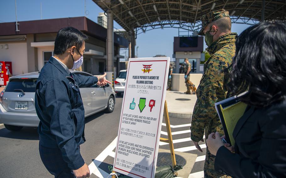 Col. Lance Lewis, commander of Marine Corps Air Station Iwakuni in Japan, shows Iwakuni city Mayor Yoshihiko Fukuda the precautionary measures in place at the base to prevent the spread of the coronavirus, April 14, 2020.