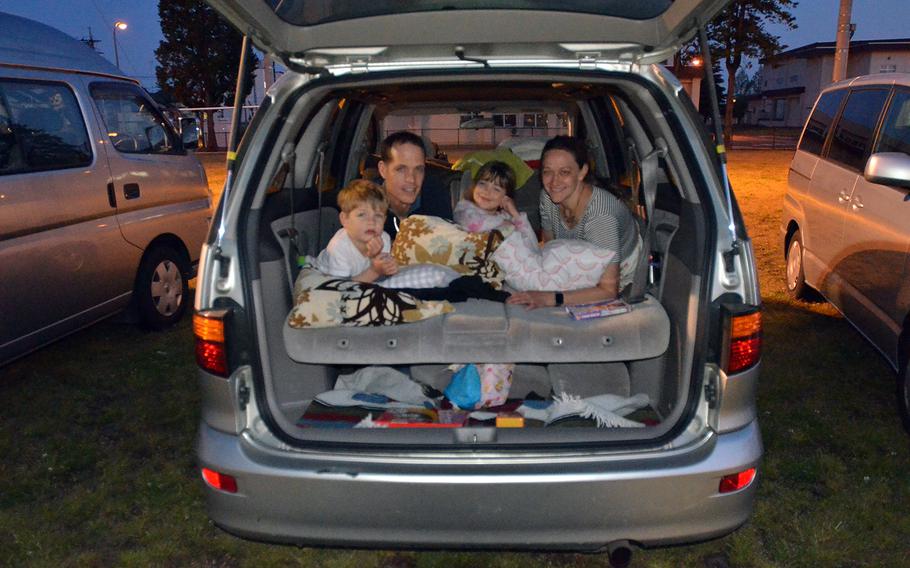 Air Force Col. Doyle Pompa of Albuquerque, N.M., prepares to watch a drive-in movie with his wife, Gina, daughter Helena and son Rocco at Yokota Air Base, Japan, Saturday, April 25, 2020.