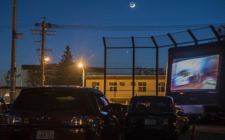 Families in cars watch a free showing of "Toy Story 4" on an inflatable outdoor screen at Yokota Air Base, Japan, Saturday, April 25, 2020.