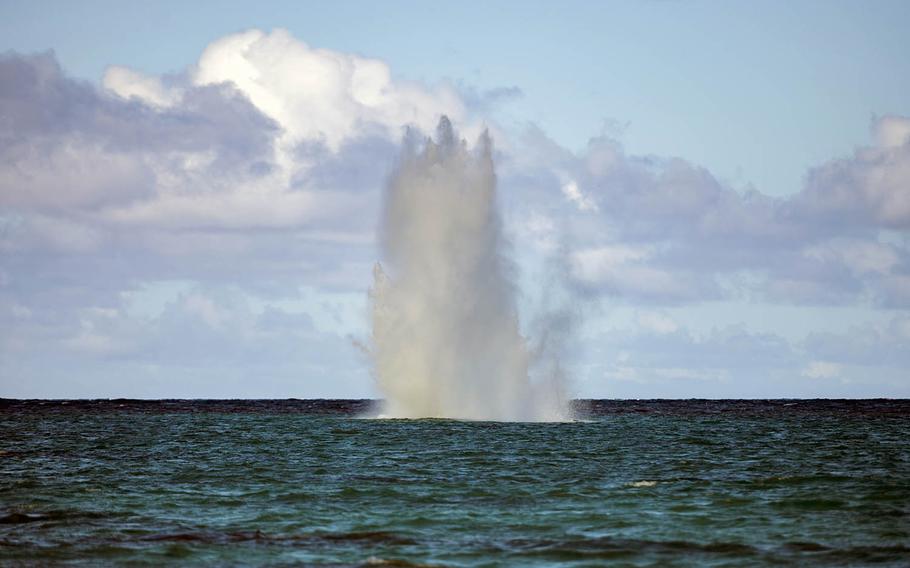 Water erupts just off Lanikai Beach, Oahu, Hawaii, from the controlled detonation of two World War II-era gravity bombs by Navy ordnance experts.