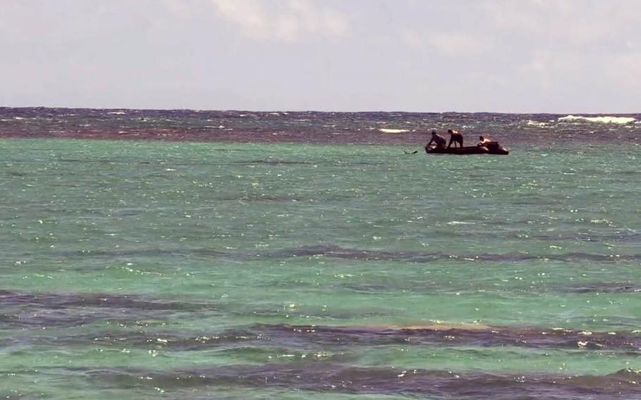 Sailors assigned to Mobile Diving Salvage Unit 1 Detachment use an inflatable dinghy April 27, 2020, as they place an underwater charge to detonate World War II-era bombs found near a popular Oahu, Hawaii, beach.