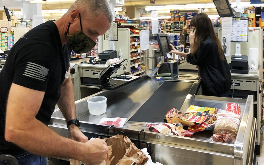 Col. Vincent Ciuccoli, commander of Camps Foster and Lester on Okinawa, purchases groceries at the Foster commissary for people who requested items through Fidelis Rides' new U-Shop service, Wednesday, April 29, 2020.