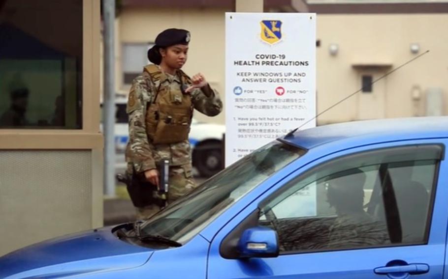 Airmen demonstrate coronavirus gate-screening procedures at Yokota Air Base, Japan, in this screenshot from a video created last month by the 374th Airlift Wing.