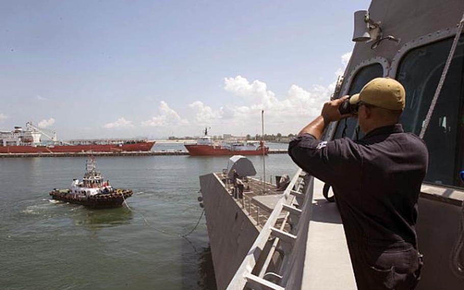 Petty Officer 2nd Class Eric Del Rio stands lookout as the littoral combat ship USS Montgomery arrives at Changi Naval Base in Singapore, July 6, 2019.