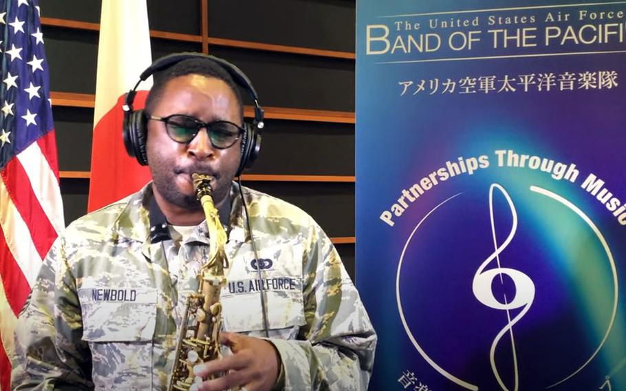 This YouTube screenshot shows Senior Airman Derrick Newbold of the Air Force Band of the Pacific-Asia performing a solo for a cover version of the theme song for the Japanese anime series "Cowboy Bebop."