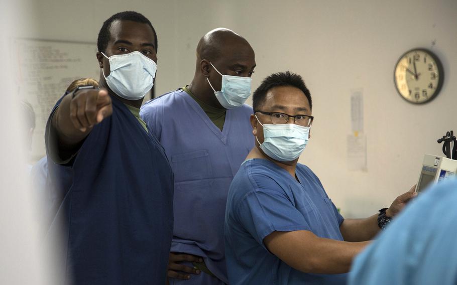 Navy Lt. Rodney Posley, left, an intensive care unit nurse with 3rd Medical Battalion at Camp Foster, Okinawa, trains a pair of hospital corpsmen at Naval Base Guam, April 24, 2020.