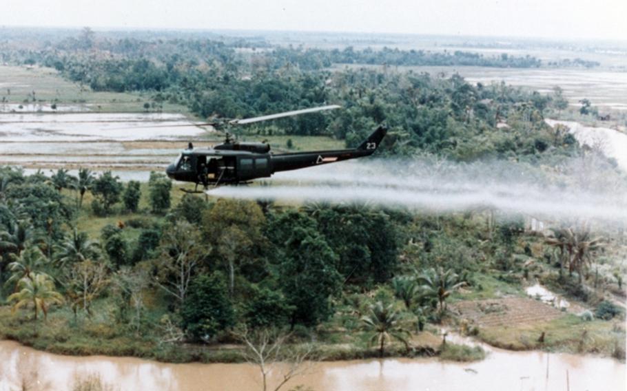 An Army Huey helicopter sprays Agent Orange herbicide and defoliant in this undated photo from the Vietnam War.