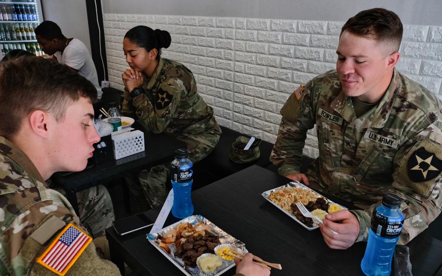 Sgt. Shawn Fowler, right, enjoys a  meal with his troops at a restaurant outside Camp Humphreys, South Korea, on Wednesday, May 20, 2020.