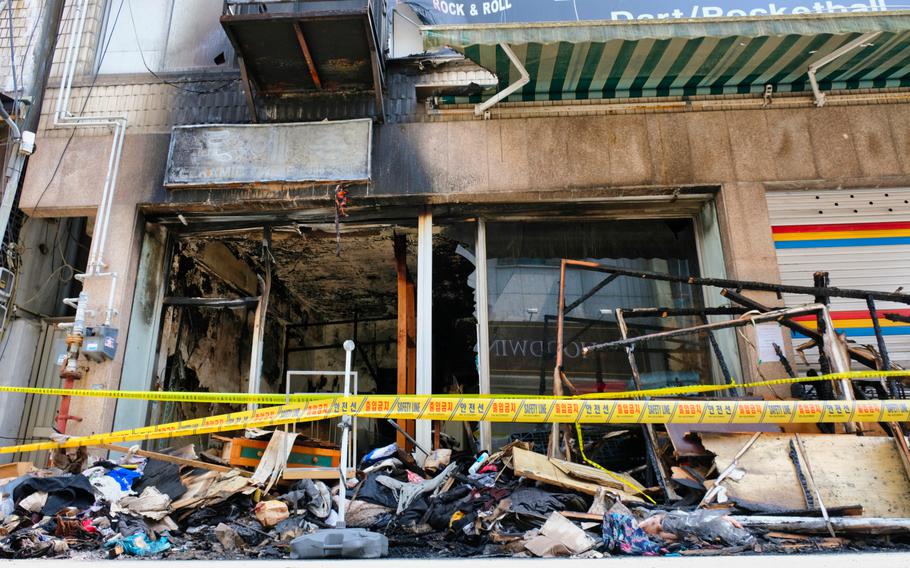Debris is piled outside a blanket shop that caught fire near Osan Air Base, South Korea, on Friday, May 15, 2020.  A team of airmen and South Korean soldiers on a routine patrol outside Osan became impromptu firefighters when they arrived first at a burning blanket shop on May 15.