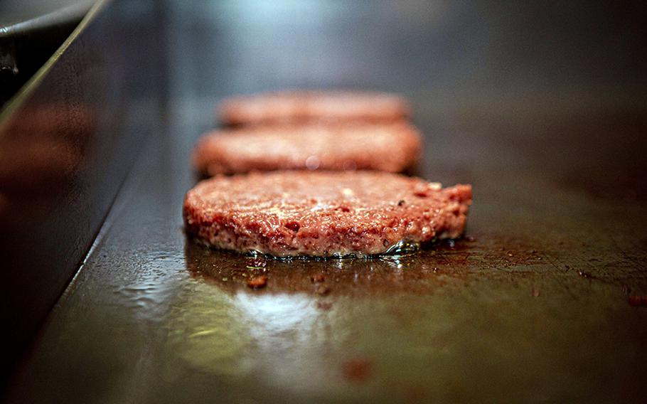 A meatless Impossible Burger cooks on a grill at Marine Corps Air Station Futenma, Okinawa,  May 13, 2020.