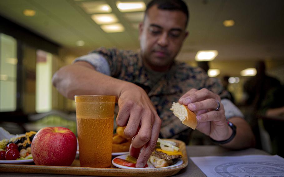 Marine Corps Staff Sgt. Obaid Halim, an aviation ordnance system technician for the 1st Marine Aircraft Wing, tries an Impossible Burger at Marine Corps Air Station Futenma, Okinawa, Japan, May 13, 2020.