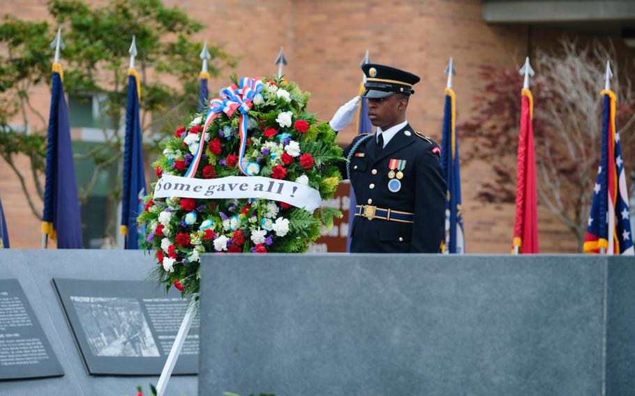 An honor guard soldier salutes during a Memorial Day ceremony outside U.S. Forces Korea headquarters at Camp Humphreys, South Korea, Monday, May 25, 2020.